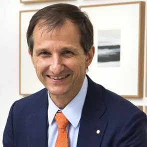a man in a suit and orange tie